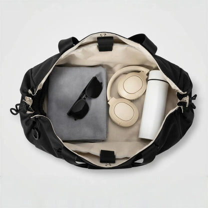 CourtDuet Bag in Court Black interior packed with towel, headphones and water bottle