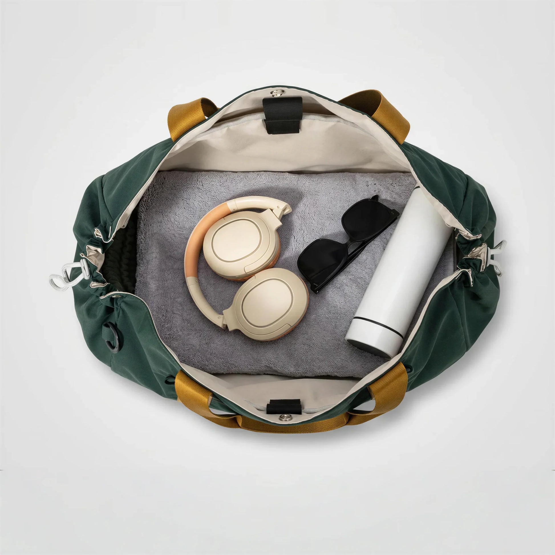 CourtDuet Bag in Court Forest interior packed with towel, headphones and water bottle